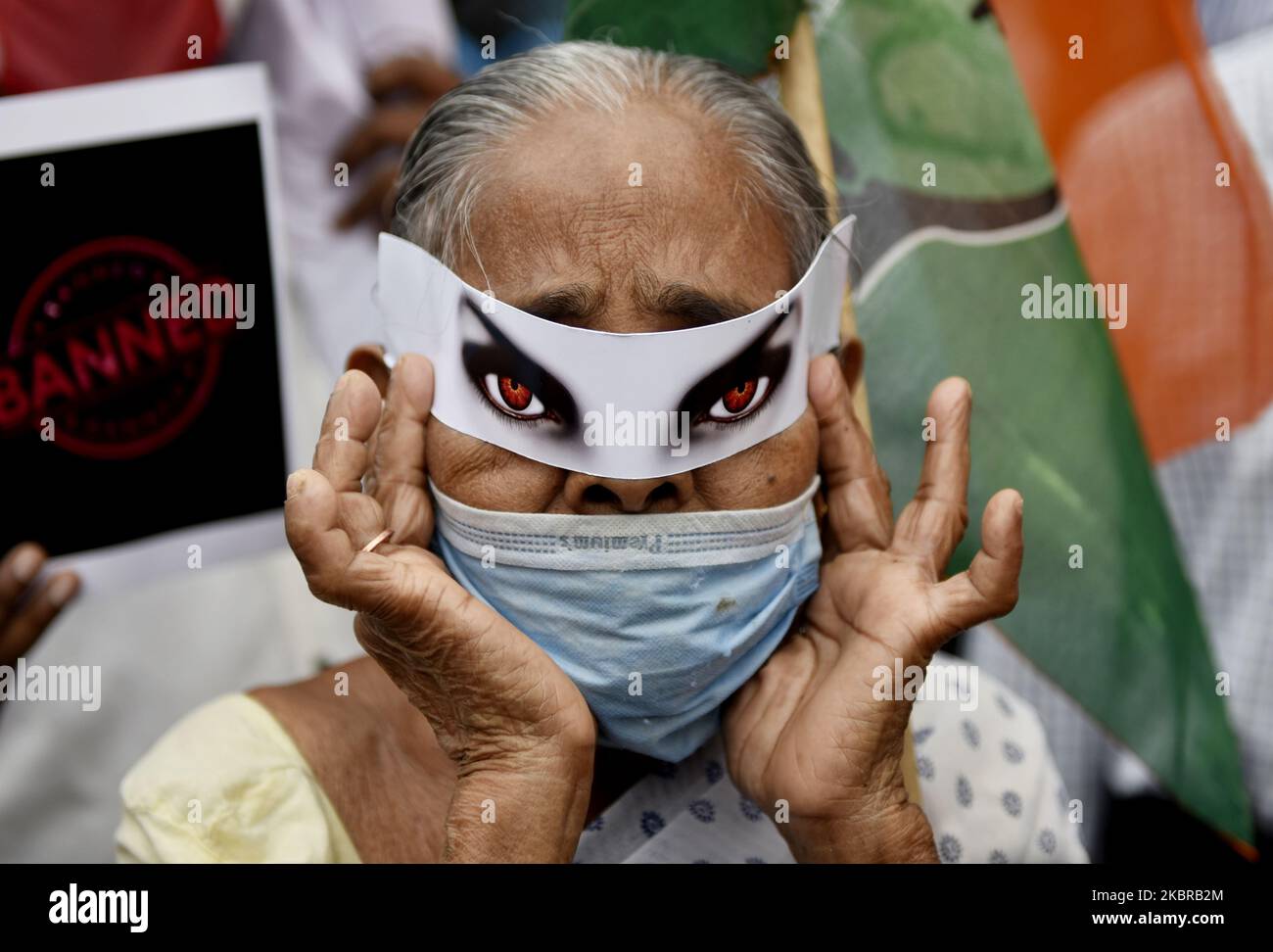 A Congress party supporter wears a mask with red eyes during an anti-China demonstration in Kolkata on June 18, 2020. India and China agreed on June 17 to ease tensions at their disputed Himalayan border, even as they traded blame for a brawl that left at least 20 Indian soldiers dead according to an Indian media report. (Photo by Indranil Aditya/NurPhoto) Stock Photo