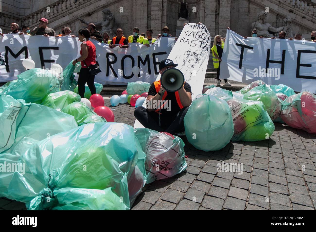 Workers of non-household users, a contract managed by Multiservizi, protest in Piazza del Campidoglio fake garbage bags on the square on June 18, 2020 in Rome , Italy. 'Welcome to Rome, the city of rubbish' the banner displayed by protesters. With the downsizing of the door-to-door service for non-household users by Ama, Multiservizi has left the contract and now 270 operators risk losing their jobs. (Photo by Andrea Ronchini/NurPhoto) Stock Photo