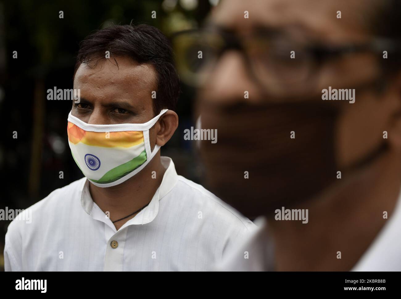 A man wears a protective face mask of an Indian National Flag amid ...