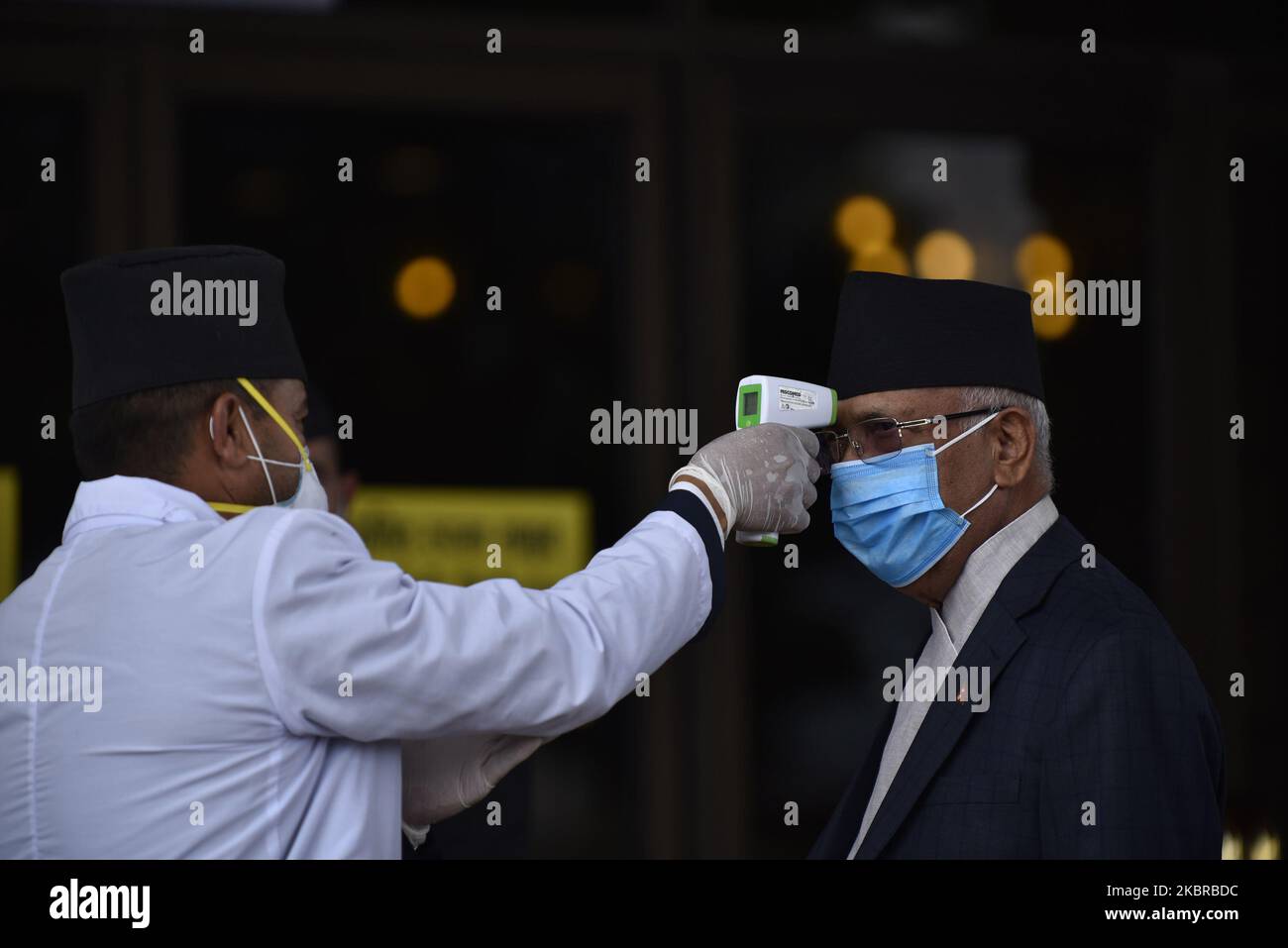 Prime Minister KP Sharma Oli checks the body temperature before to speak in the National Assembly on the Constitution amendment bill at Kathmandu, Nepal on Thursday, June 18, 2020. The National Assembly unanimously adopts Constitution amendment bill. (Photo by Narayan Maharjan/NurPhoto) Stock Photo