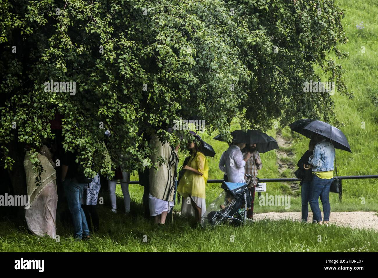 Heavy rain caught people who gathered near Krakus Mound to celebrate 'Kupala Night' in Krakow, Poland on June 20th, 2020. Kupala Night is a traditional eastern Slavic holiday related to the summer solstice on the shortest night of the Year. (Photo by Beata Zawrzel/NurPhoto) Stock Photo