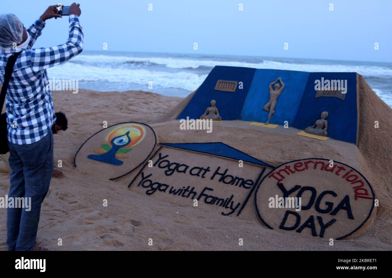 A sand sculpture is seen carrying International Yoga Day message