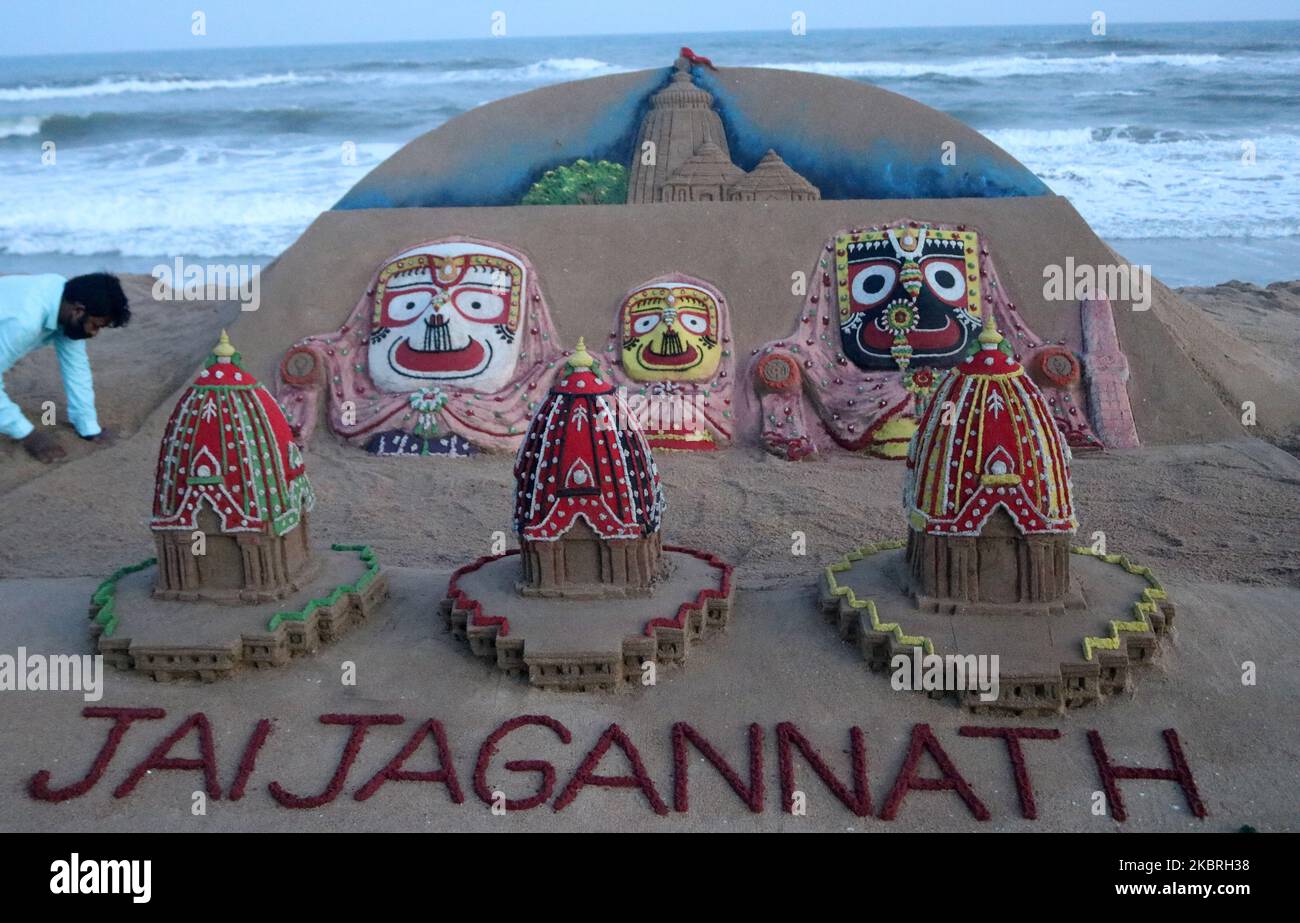 Indian sand artist Sudarshan Patnaik creating a sand sculpture on the