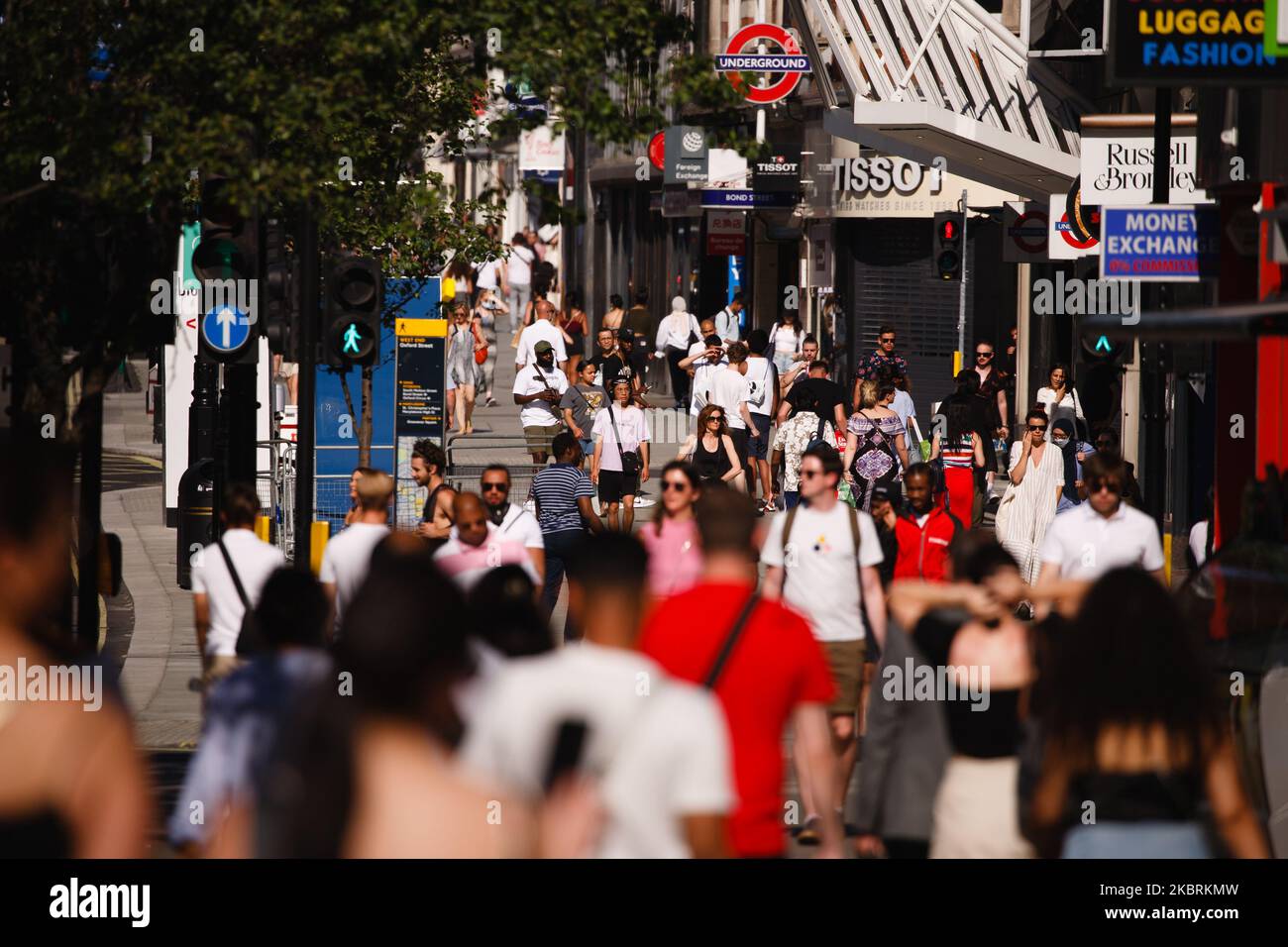 Shoppers walk along Oxford Street in heatwave conditions in London, England, on June 25, 2020. Temperatures rose to 33C in parts of London today, in what has been one of the UK's hottest days of the year so far. Central London was nonetheless busy with shoppers this afternoon as the retail sector mounts its comeback after coronavirus lockdown restrictions on non-essential shops were eased at the beginning of last week. Among retailers, confidence is reportedly low that recovery will be swift, however, with a survey from the Confederation of British Industry (CBI) today revealing fears of reduc Stock Photo