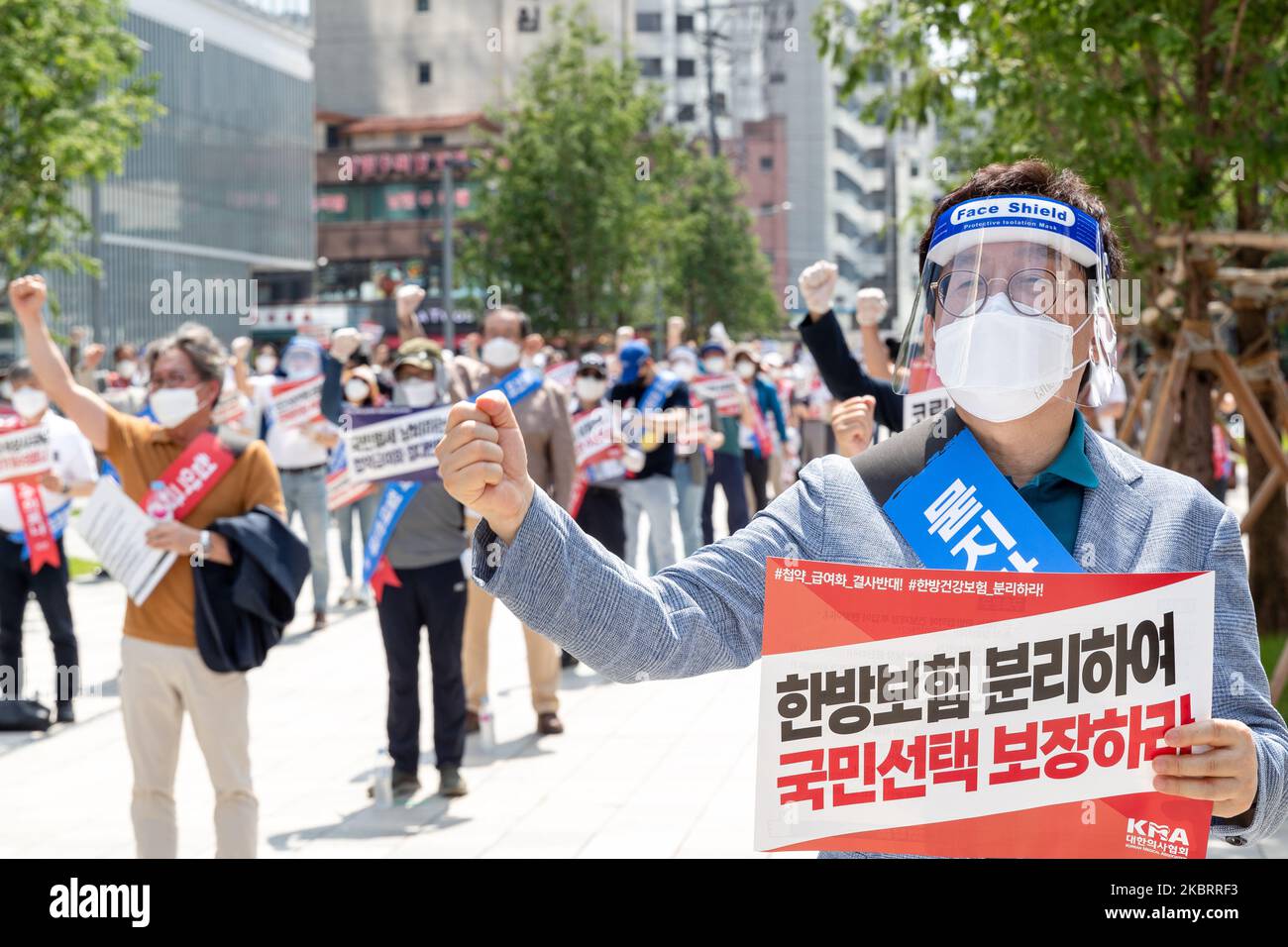 A hundred members of the Korean Medical Association shout slogans during a protest against the application of health insurance for Traditional Korean medicine at Hanbit squre in Seoul, South Korea on the June 28, 2020. The government plans to conduct a pilot project to apply health insurance benefits to the aftereffects of cerebrovascular disease, facial nerve paralysis, menstrual pain and will be confirmed at the Health Insurance Policy Review Committee meeting next month. (Photo by Chris Jung/NurPhoto) Stock Photo