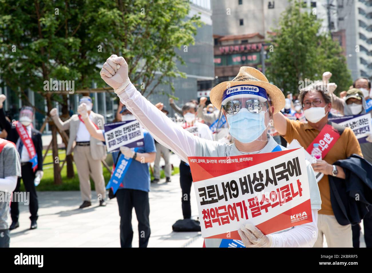 A hundred members of the Korean Medical Association shout slogans during a protest against the application of health insurance for Traditional Korean medicine at Hanbit squre in Seoul, South Korea on the June 28, 2020. The government plans to conduct a pilot project to apply health insurance benefits to the aftereffects of cerebrovascular disease, facial nerve paralysis, menstrual pain and will be confirmed at the Health Insurance Policy Review Committee meeting next month. (Photo by Chris Jung/NurPhoto) Stock Photo