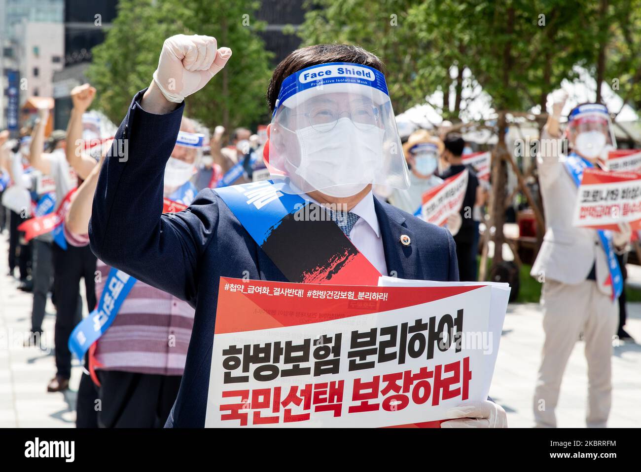 A hundred members of the Korean Medical Association shout slogans during a protest against the application of health insurance for Traditional Korean medicine at Hanbit squre in Seoul, South Korea on the June 28, 2020. The government plans to conduct a pilot project to apply health insurance benefits to the aftereffects of cerebrovascular disease, facial nerve paralysis, menstrual pain and will be confirmed at the Health Insurance Policy Review Committee meeting next month. (Photo by Chris Jung/NurPhoto) Stock Photo