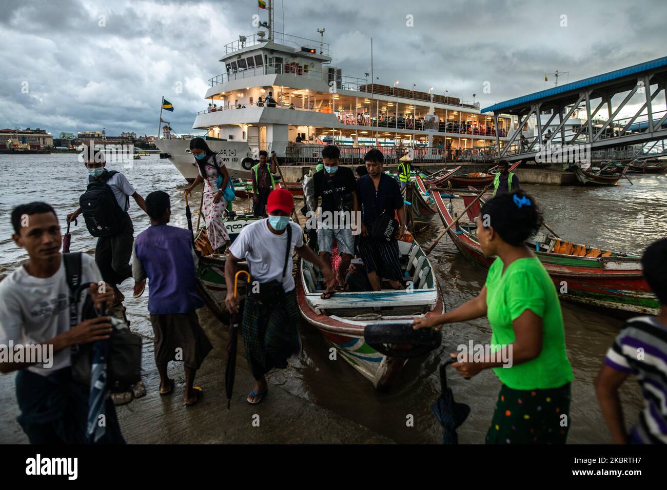 Commuters disembark a small ferry boat at Dala ferry terminal in Yangon on June 29, 2020. (Photo by Shwe Paw Mya Tin/NurPhoto) Stock Photo