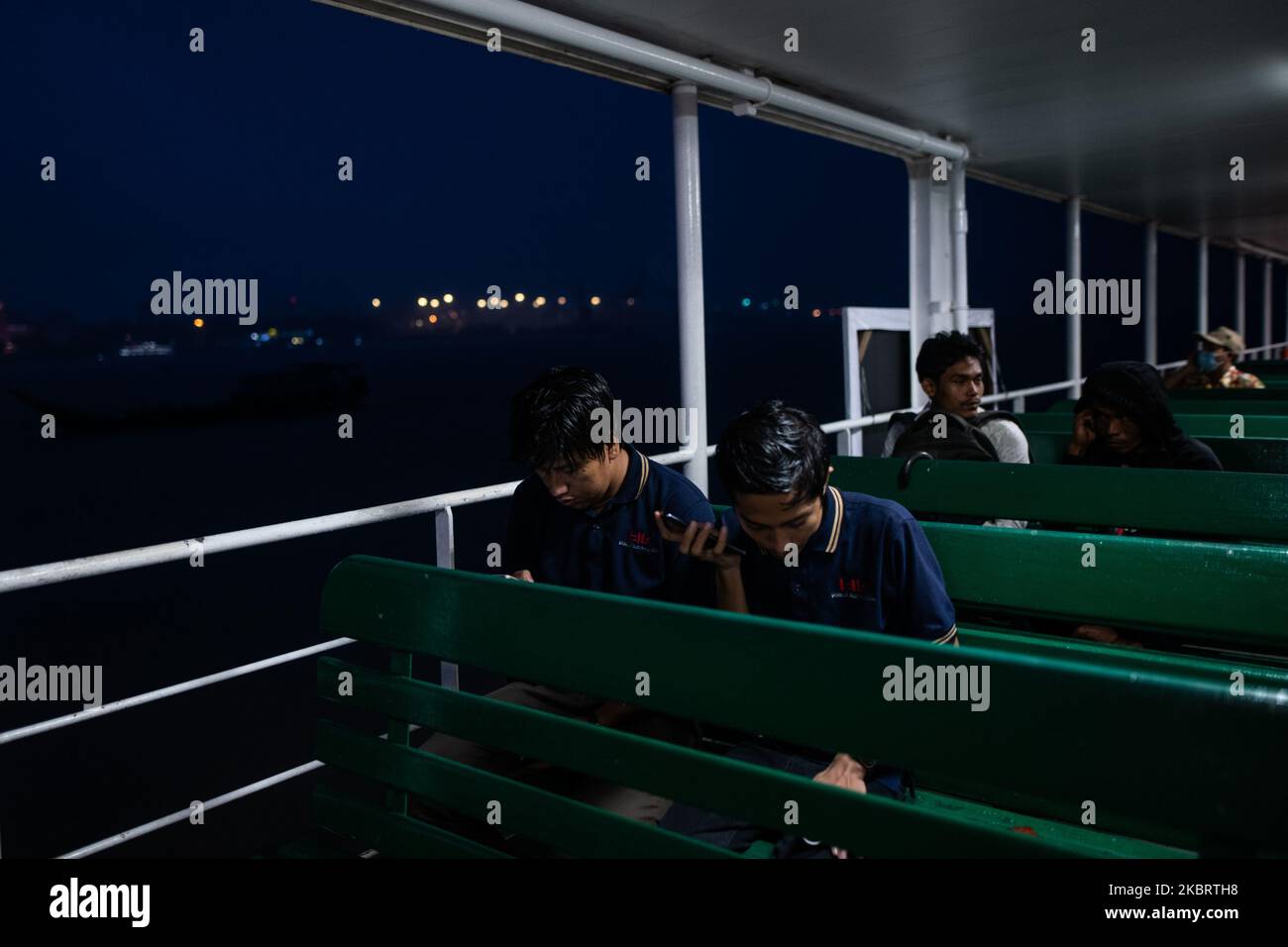 Commuters use their mobile phone as they take a ferry to cross Yangon river in Yangon on June 29, 2020. (Photo by Shwe Paw Mya Tin/NurPhoto) Stock Photo