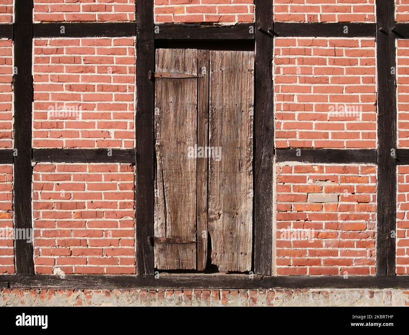 Old door in rustic brick wall Stock Photo