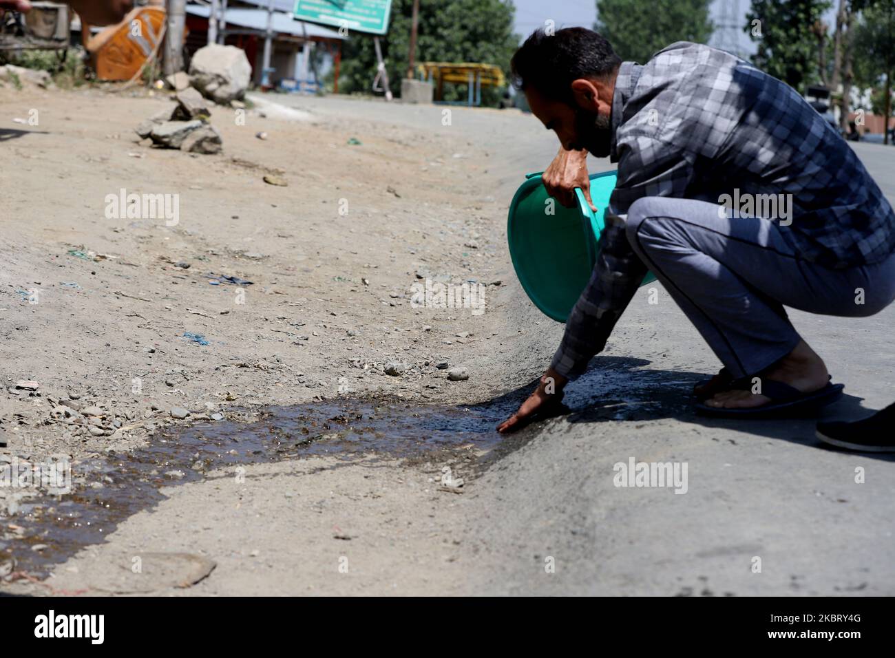 A man washes the blood near the shootout site after millitants attacked CPRF party in Sopore town of district baramulla Jammu and Kashmir, India on 01 July 2020 (Photo by Nasir Kachroo/NurPhoto) Stock Photo