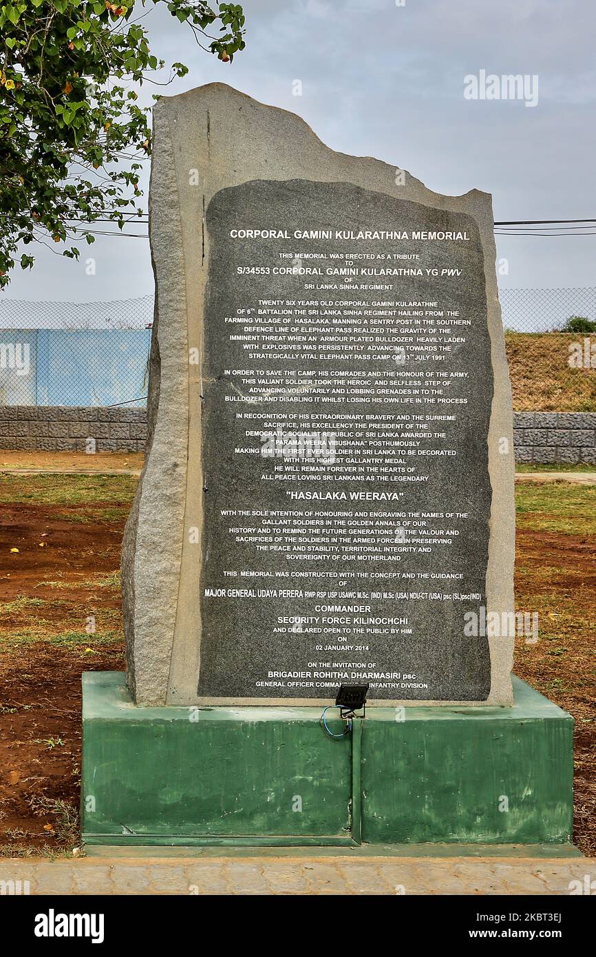 Information plaque at the Hasalaka War Hero War Memorial (Hasalaka Gamini War Memorial) located at the Elephant Pass, Northern Province, Sri Lanka on August 10, 2017. Corporal Gamini Kularatne was killed on 14 July 1991 while preventing an armored bulldozer belonging to the Liberation Tigers of Tamil Eelam (LTTE) from ramming into the Elephant Pass Army garrison during the First Battle of Elephant Pass. Corporal Kularatne used two hand grenades to kill the four-man crew inside the bulldozer and disabled the armored vehicle before being killed. Elephant Pass is a causeway which is the main gate Stock Photo