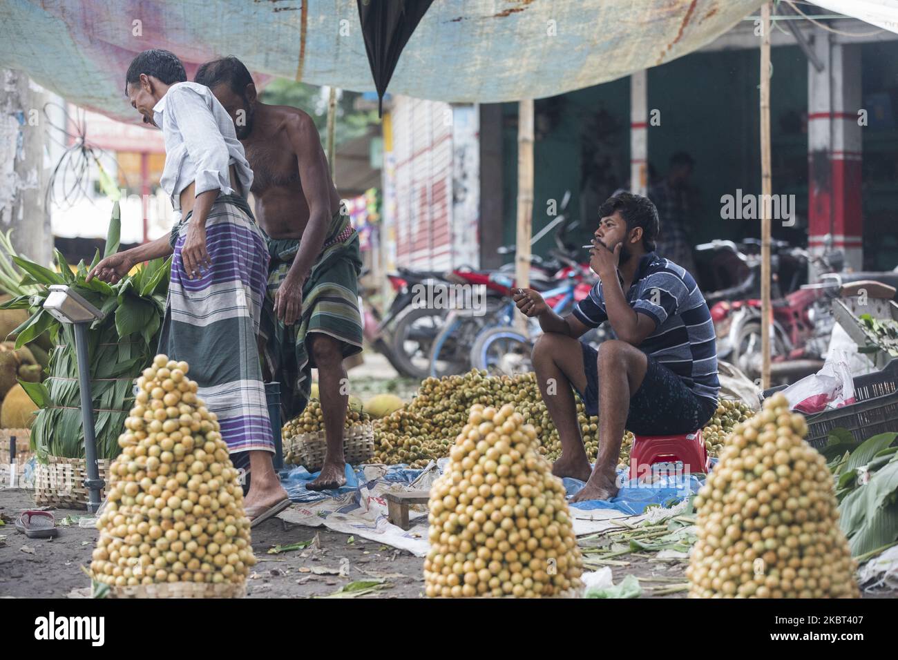 Farmers process Ripe Burmese grape, locally known as latkan, in Narsingdi, Bangladesh on July 4