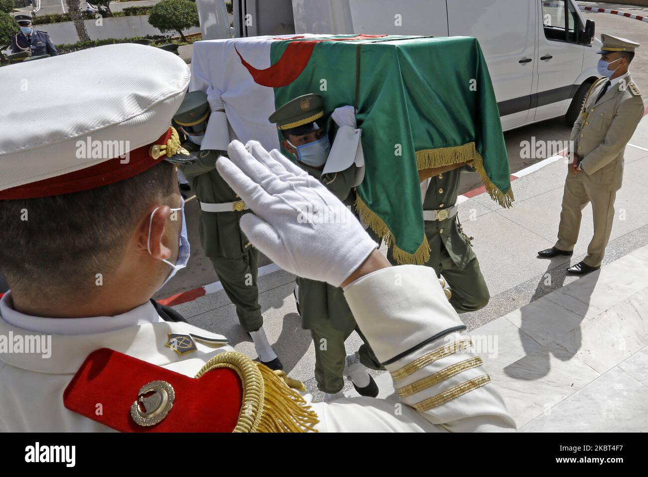 A soldier stands guard next to the national flag-draped coffins containing the remains of 24 Algerian resistance fighters decapitated during the French occupation, at the Moufdi-Zakaria culture palace in Algiers, Algeria, 04 July 2020. France returned the skulls of 24 Algerians who fought against the French colonial occupation of Algeria that began in 1830. The skulls were kept at a museum in Paris since the 19th century while Algeria had been for years demanding repatriation for their burial. (Photo by Billal Bensalem/NurPhoto) Stock Photo