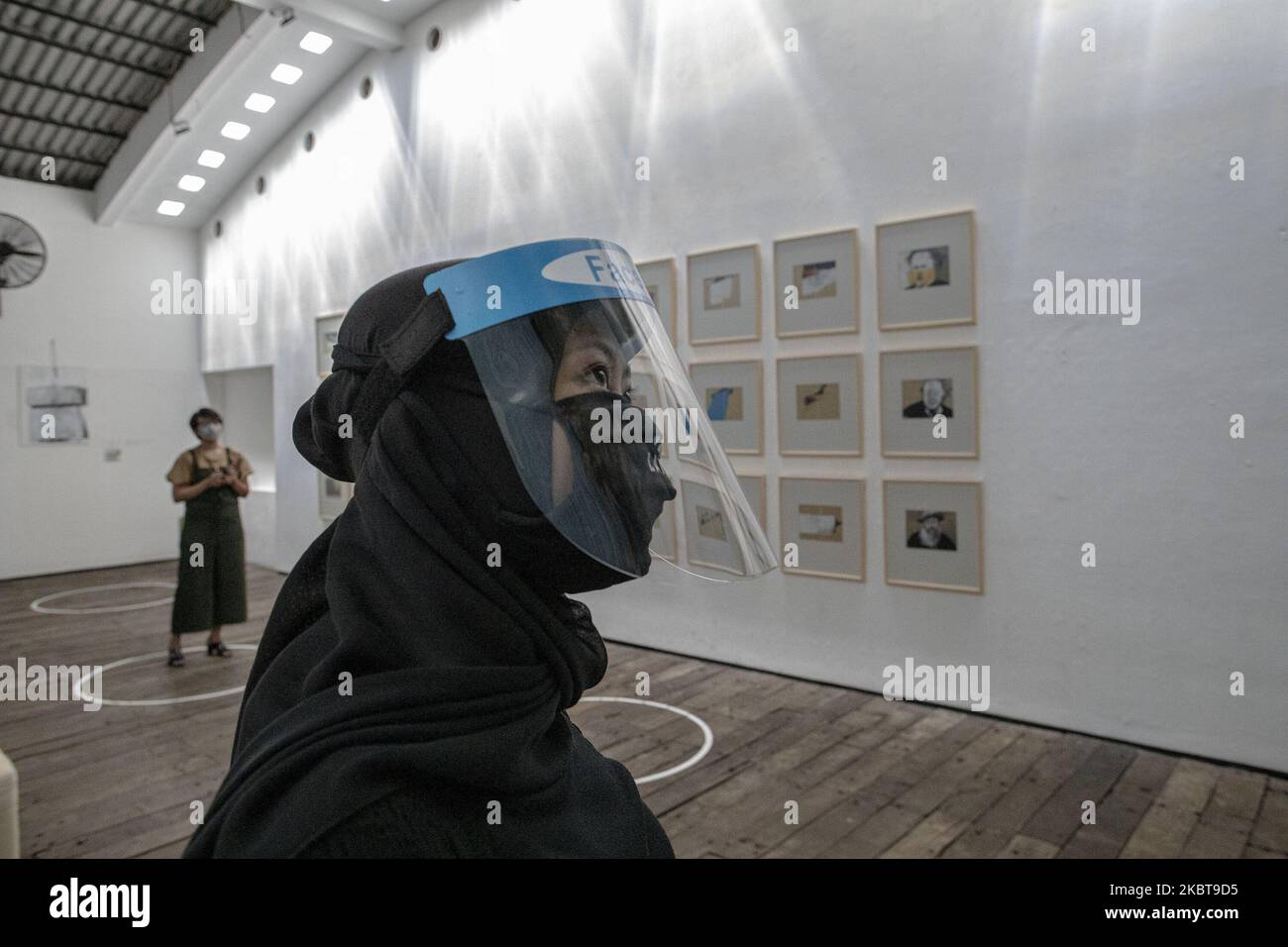 Visitors at Art Exhibition at Hanafi Gallery in Depok West Java, Indonesia, on July 9, 2020. HANAFI the painter exhibit his work during partial lock down that made him stay at home for over 4 months. The art exhibition applied health protocol using mask, distance marking, and face shield (Photo by Donal Husni/NurPhoto) Stock Photo