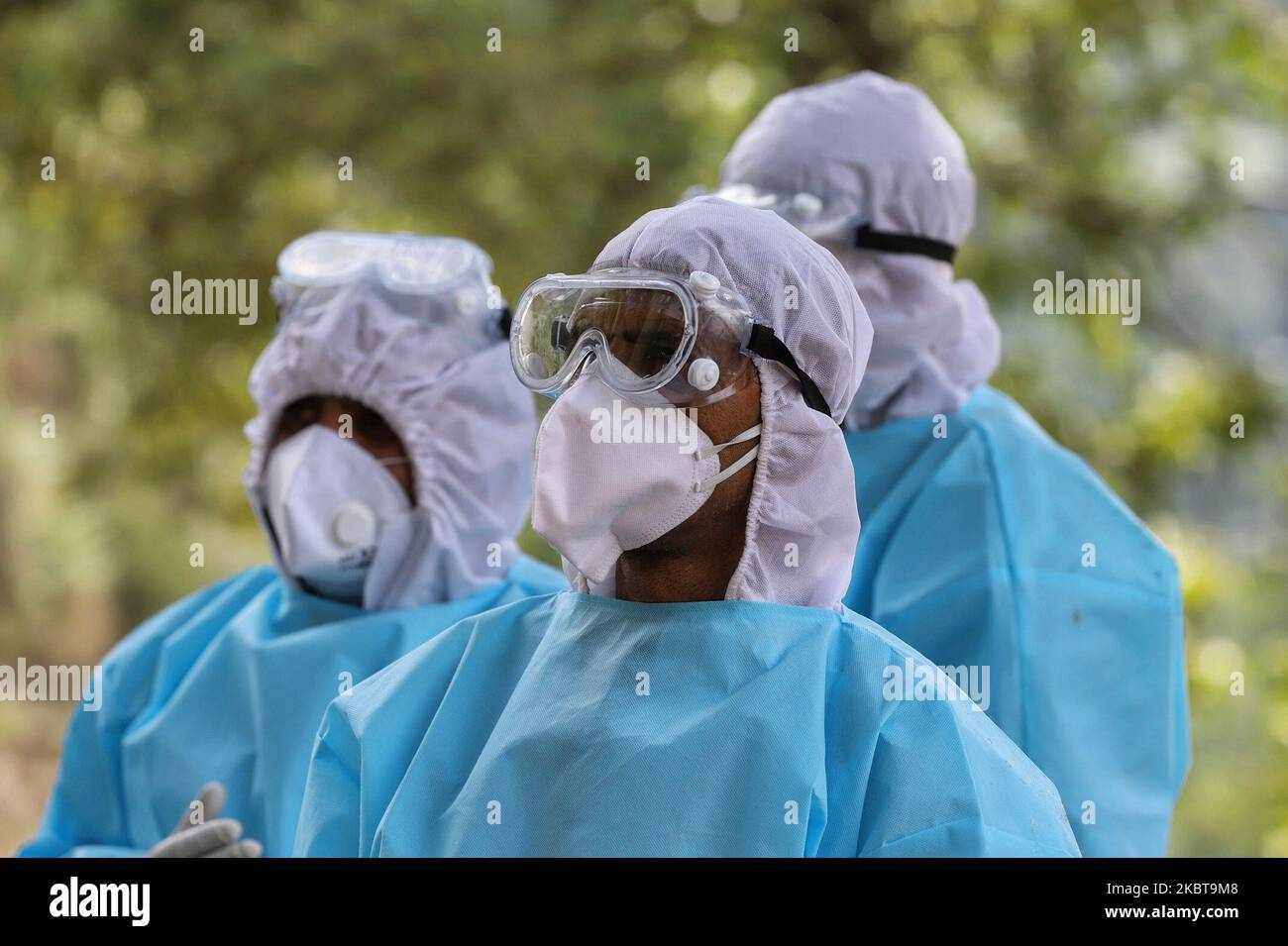 Health officials in PPE overalls looks on during COVID19 (coronavirus