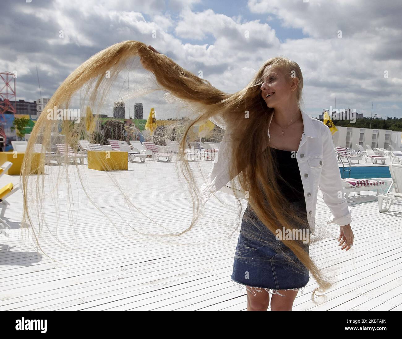 Ukrainian Olena Korzenyuk, 17, shows her hair wich is 2.35 meters long, at the National Registry of Records of Ukraine presentation in Kyiv, Ukraine, on 09 July, 2020. Olena Korzenyuk is considered the record holder with the longest hair among teenagers in Ukraine. (Photo by STR/NurPhoto) Stock Photo