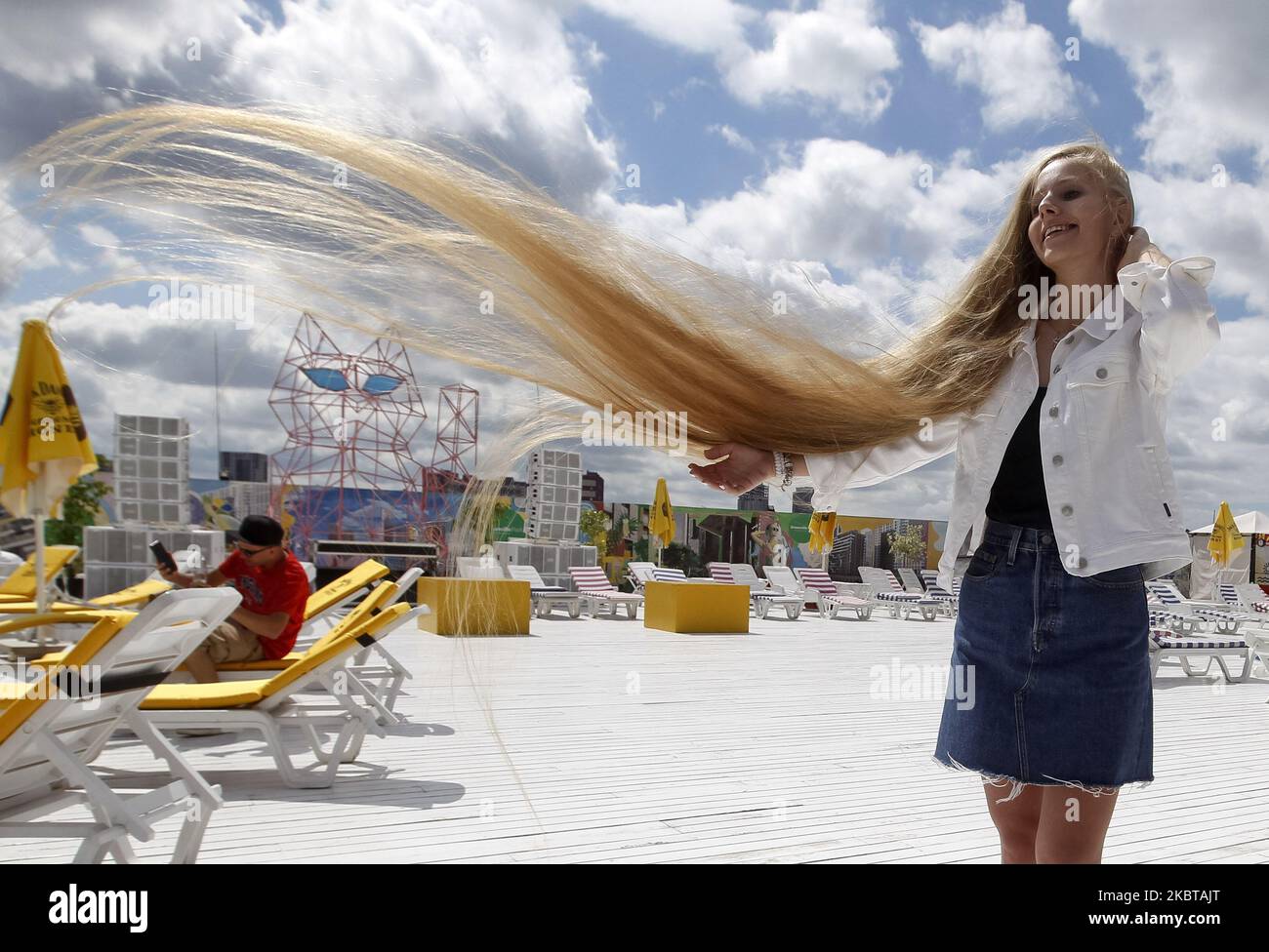 Ukrainian Olena Korzenyuk, 17, shows her hair wich is 2.35 meters long, at the National Registry of Records of Ukraine presentation in Kyiv, Ukraine, on 09 July, 2020. Olena Korzenyuk is considered the record holder with the longest hair among teenagers in Ukraine. (Photo by STR/NurPhoto) Stock Photo