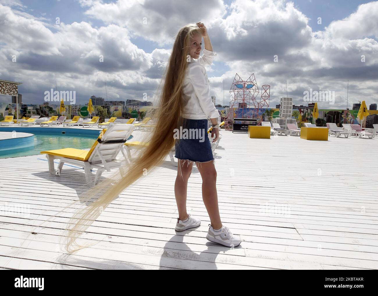 Ukrainian Olena Korzenyuk, 17, shows her hair wich is 2.35 meters long, at the National Registry of Records of Ukraine presentation in Kyiv, Ukraine, on 09 July, 2020. Olena Korzenyuk is considered the record holder with the longest hair among teenagers in Ukraine. (Photo by STR/NurPhoto) Stock Photo