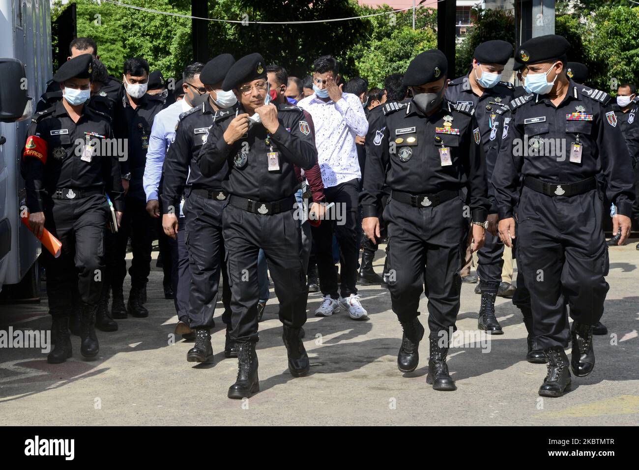 Officers of Rapid Action Battalion (RAB) walks after a press conference ...