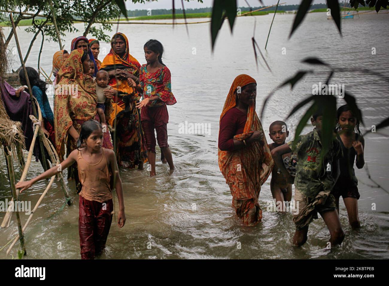 Women and children walk through flood water in Panchgachi, Kurigram on ...