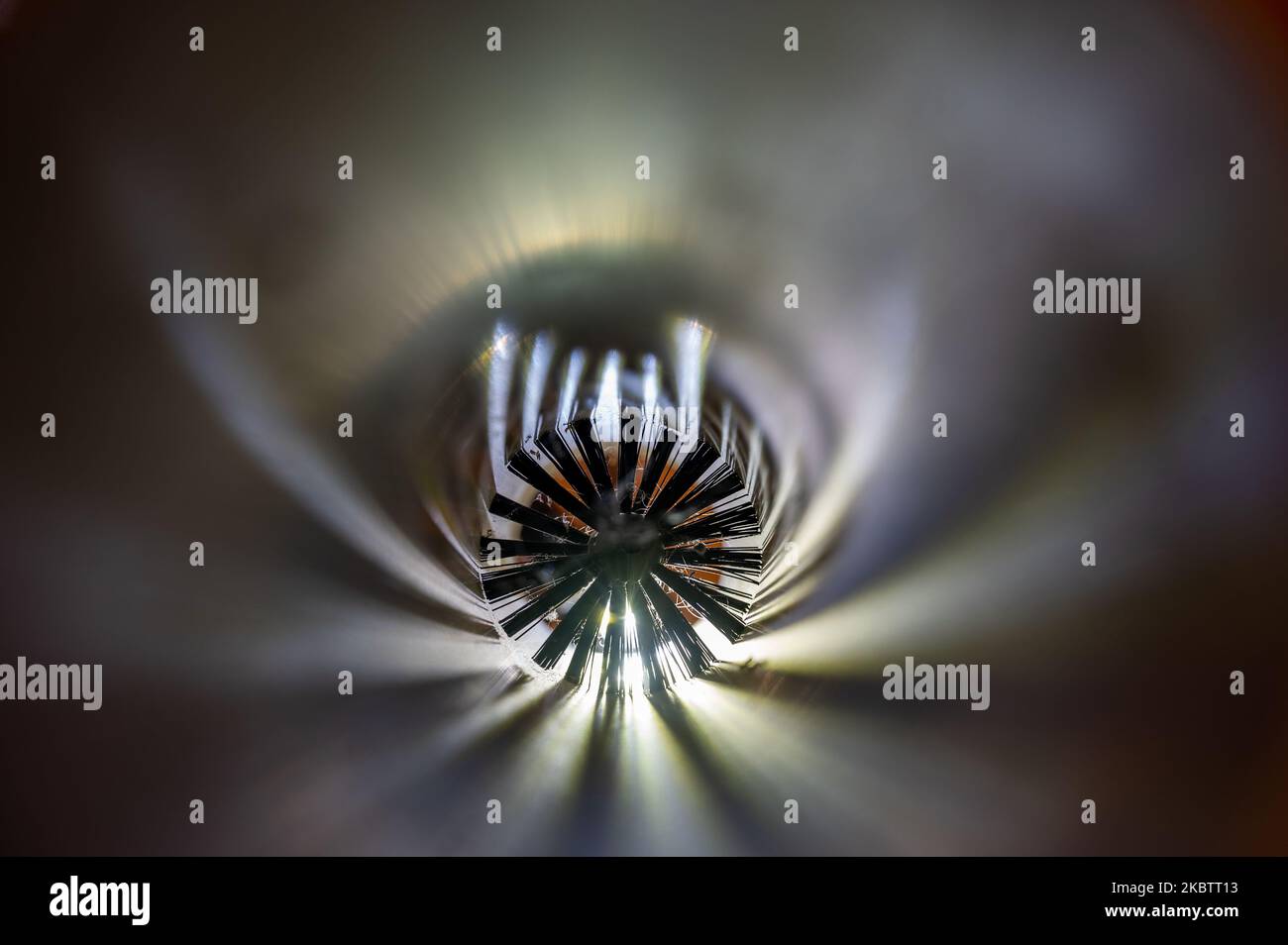 Spinning brush being used to clean out PVC tubing pipe HVAC duct Stock