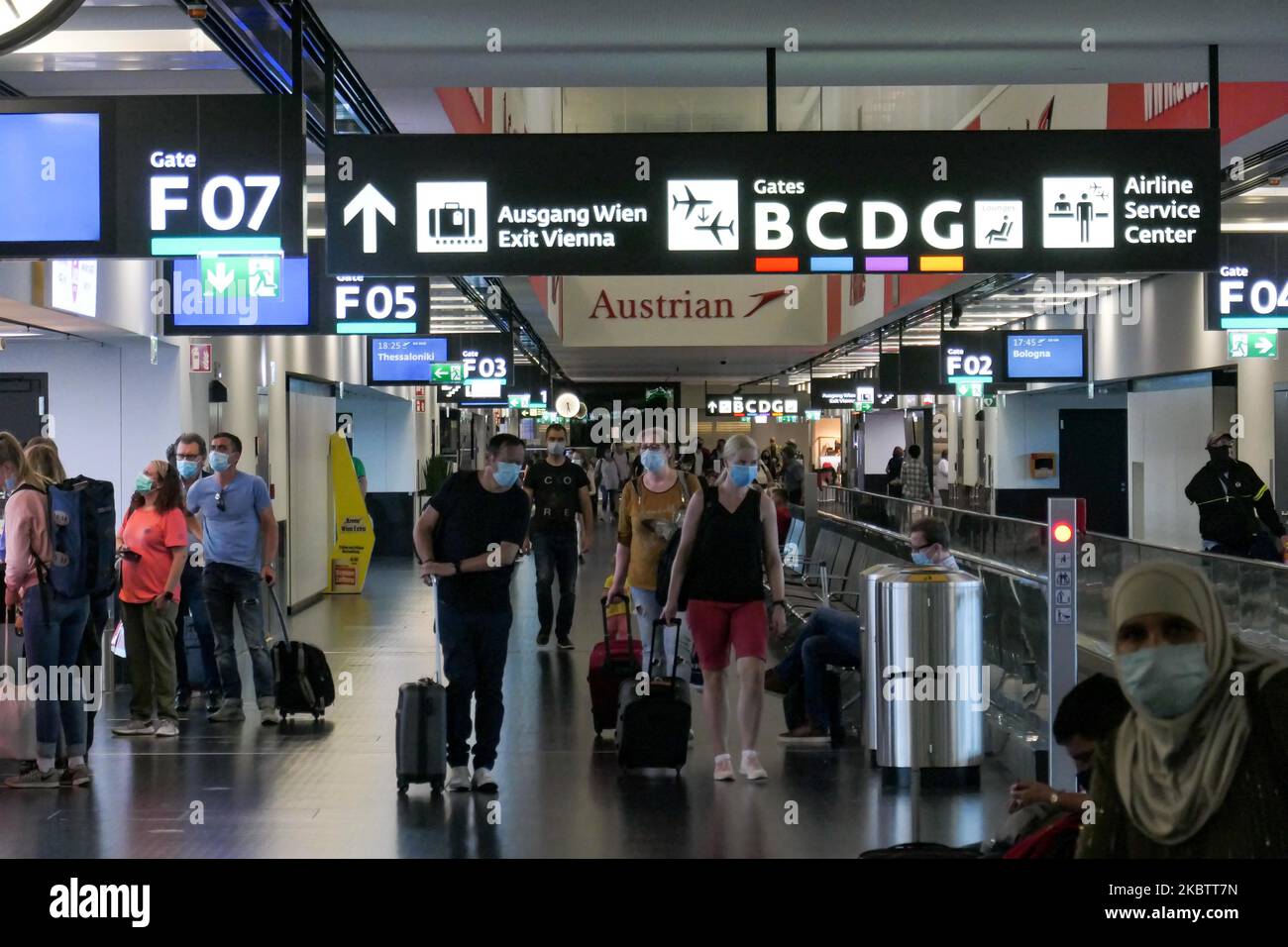 Passengers wearing facemasks, gloves and safety measures are seen on July 15, 2020 at the terminal, F Gates area of Vienna International Airport VIE LOWW - Flughafen Wien-Schwechat serving the Austrian Capital but also Bratislava as it is 55km away from the Slovak city during the Covid-19 Coronavirus pandemic era with social distancing measures and disinfecting hand sanitizer everywhere afther the lockdown period. On July 1, Austria issues travel warning for six Balkan states countries, Serbia, Montenegro, Bosnia Herzegovina, North Macedonia, Albania and Kosovo. Passengers traveling from those Stock Photo