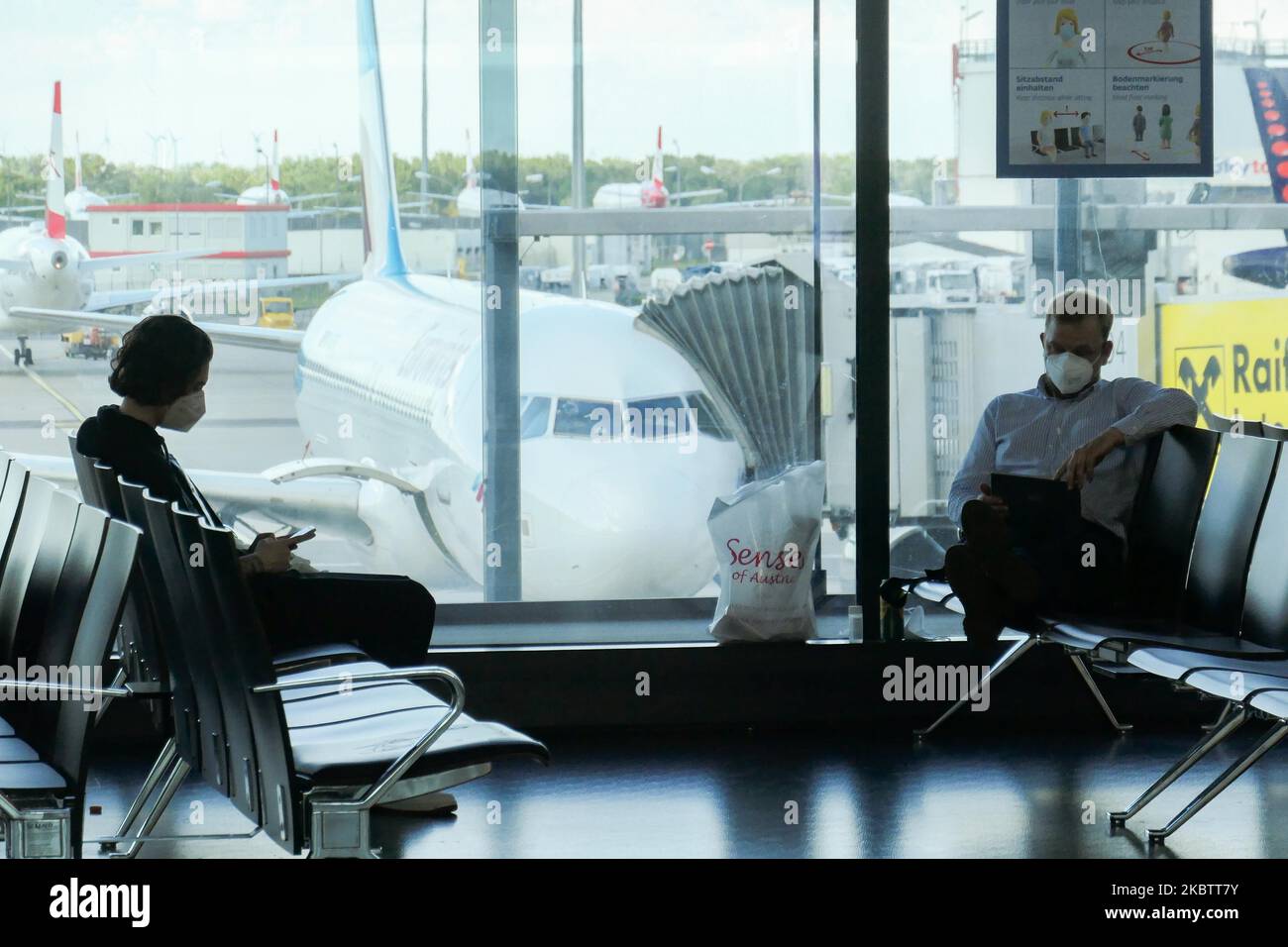 Passengers wearing facemasks, gloves and safety measures are seen on