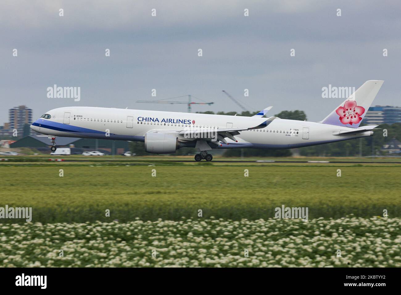 China Airlines Airbus A350-900 aircraft as seen on final approach flying, landing and touching down at Amsterdam Schiphol AMS EHAM International Airport in the Netherlands at Polderbaan runway. The Airbus A350 airplane is a new, modern, advanced, environmentally friendly, fuel-efficient wide-body plane, a long haul airliner is powered by 2x RR Rolls Royce Jet Engines and registration B-18905. The Chinese carrier China Airlines CI CAL DYNASTY is the national carrier of the Republic of China ( Taiwan ), member of SkyTeam aviation alliance, with headquarters in Taipei Taoyuan Airport in Asia. Jul Stock Photo