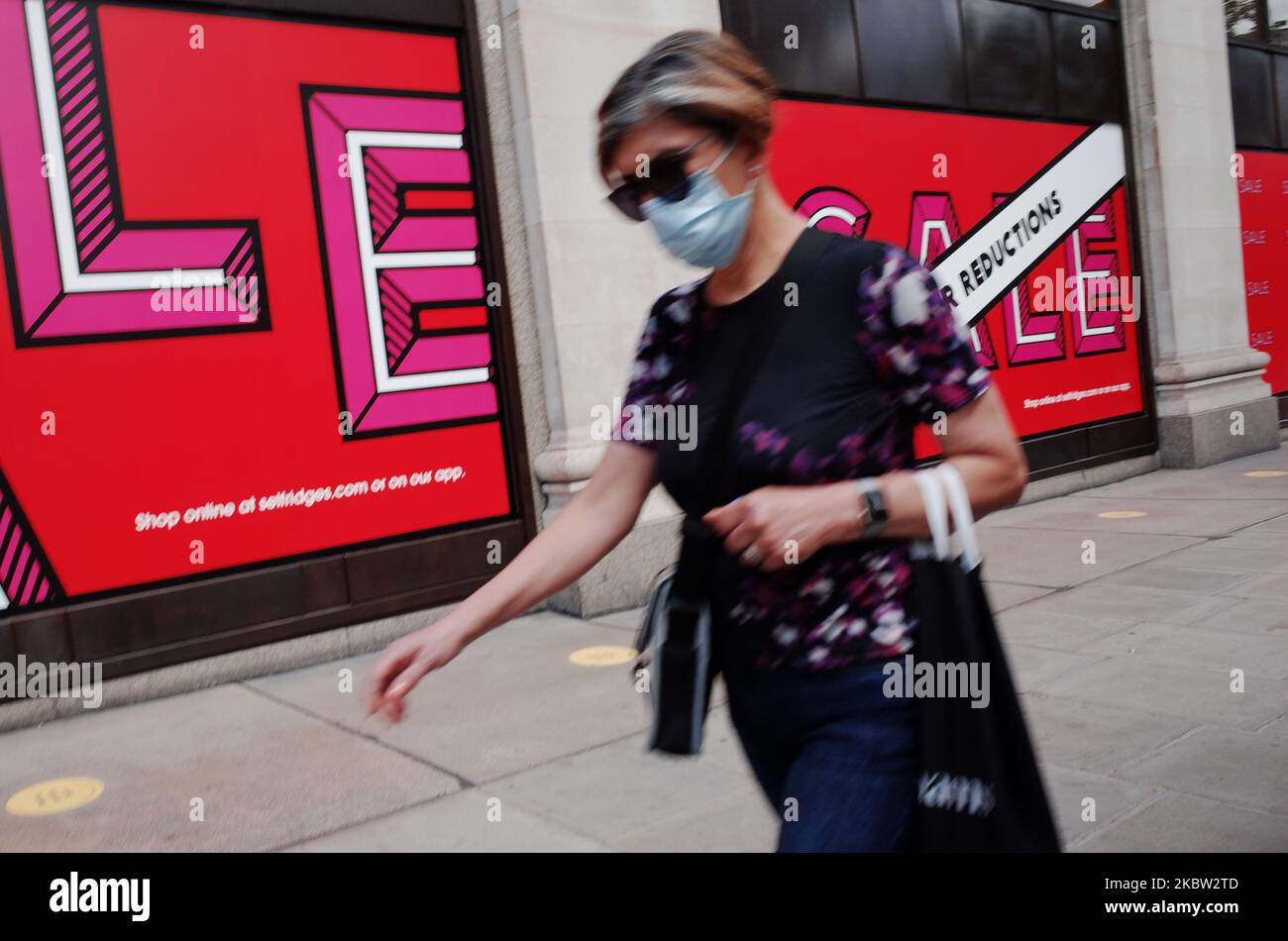 A woman walks past the Louis Vuitton shop in the Suria KLCC