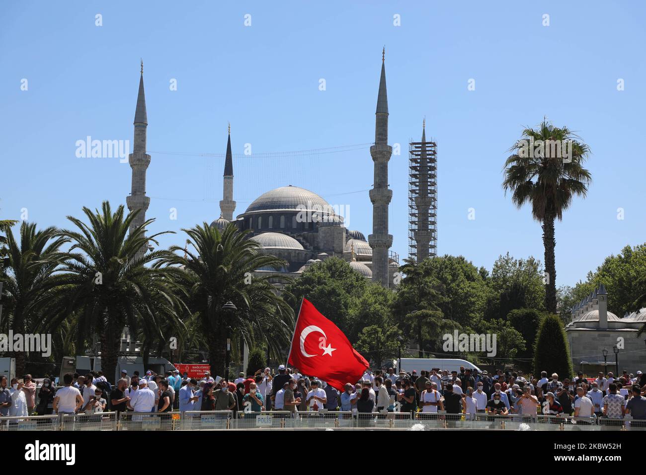 People wait for the first official Friday prayers to start outside