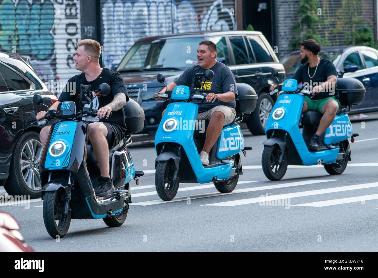 People are seen riding Revel scooters as New York City enters Phase 4 of re-opening following restrictions imposed to slow the spread of coronavirus on July 25, 2020 in New York City. The fourth phase allows outdoor arts and entertainment, sporting events without fans and media production. Scooter-share startup Revel faces questions after first death in NYC. (Photo by John Nacion/NurPhoto) Stock Photo