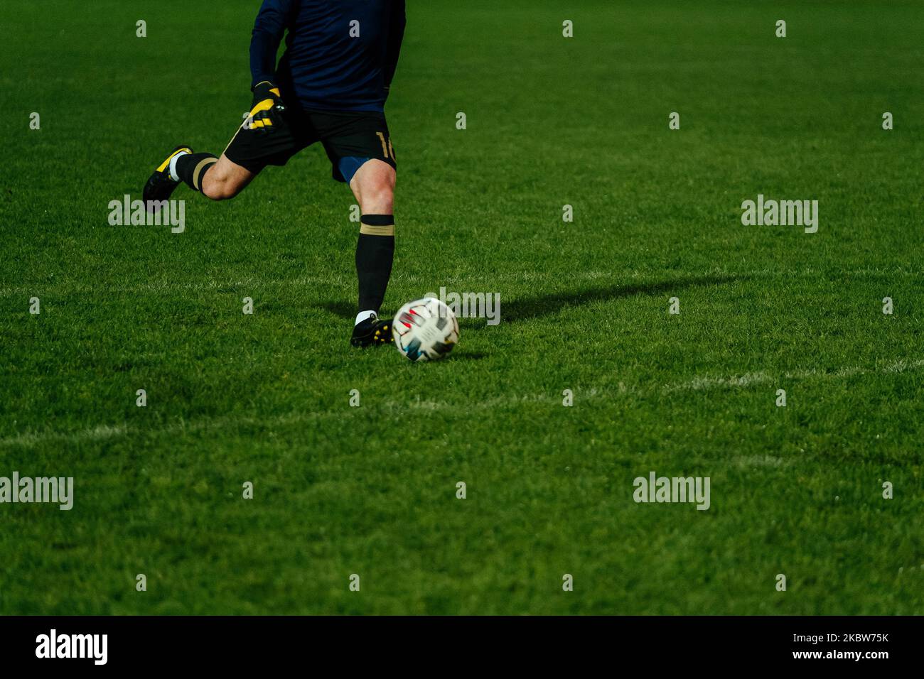 goalkeeper kick ball during football match Stock Photo