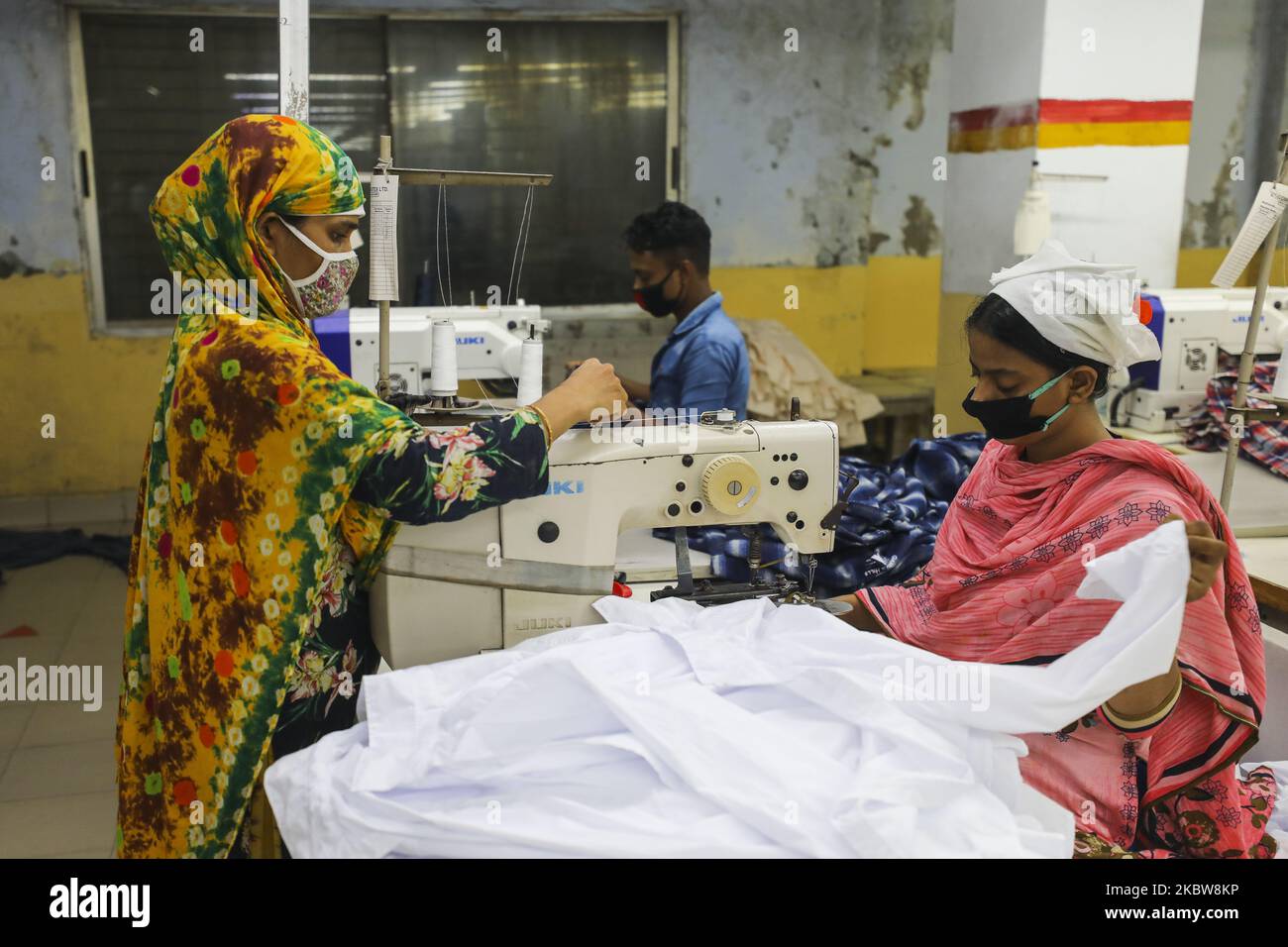 Ready made garments workers works in a garments factory in Dhaka on July 25, 2020. (Photo by