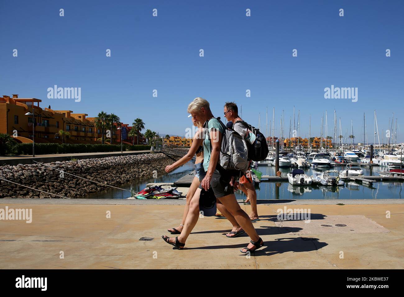Tourists walk at the Marina in Portimao, Algarve region, Portugal on July 29, 2020. Portuguese President Marcelo Rebelo de Sousa has promised to visit the Algarve every week this summer to help the regions struggling tourism sector overcome the effects of the Covid-19 pandemic and the UK governments decision to include mainland Portugal in its travel blacklist. (Photo by Pedro FiÃºza/NurPhoto) Stock Photo