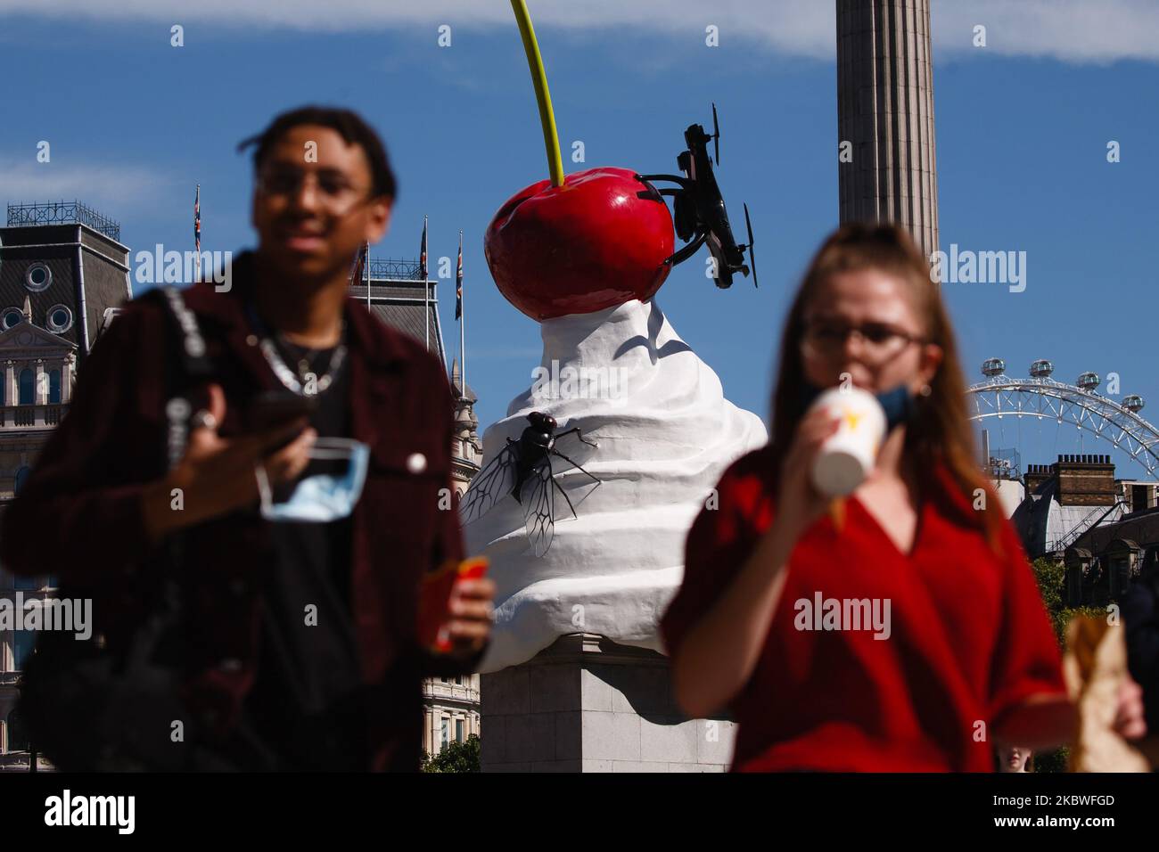 'THE END', by British artist Heather Phillipson, sits on the Fourth Plinth in Trafalgar Square in London, England, on July 30, 2020. The installation, unveiled today, has seen its debut delayed from March due to the coronavirus pandemic. Its depiction of a cherry-topped swirl of cream, plus a drone and fly, is described by its accompanying explanatory note as a 'monument to hubris and impending collapse'. The piece is the 13th commission to occupy the plinth and will remain in place until 2022. (Photo by David Cliff/NurPhoto) Stock Photo