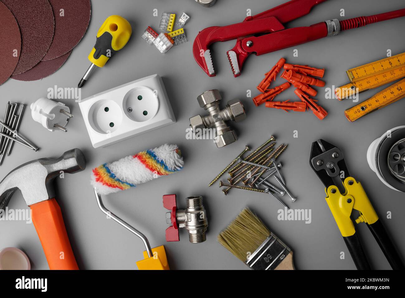 household hardware items. home improvement and repair tools on gray background. top view Stock Photo