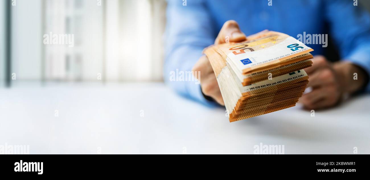 hand gives euro money banknotes. bank credit, cash loan or prize concept. banner with copy space Stock Photo