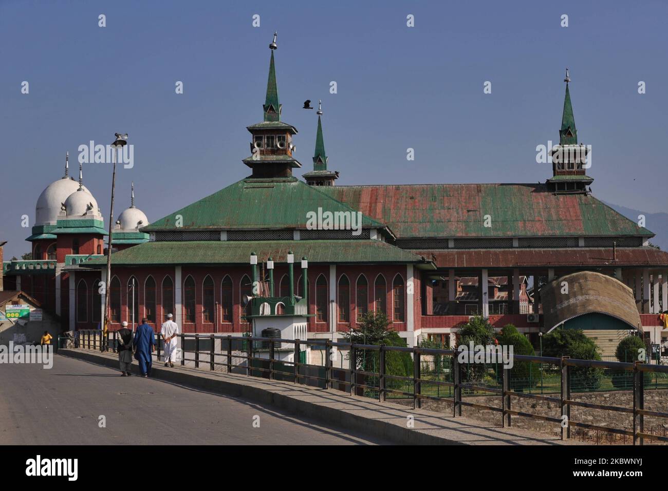 Kashmiri people walk near Jama Masjid in Sopore Town of District