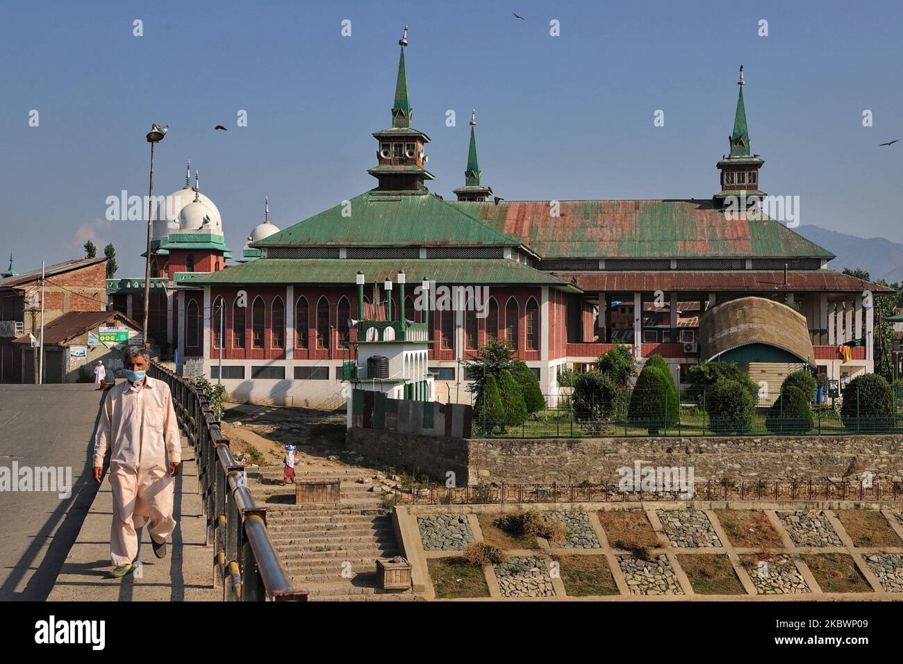 Kashmiri people walk near Jama Masjid in Sopore Town of District