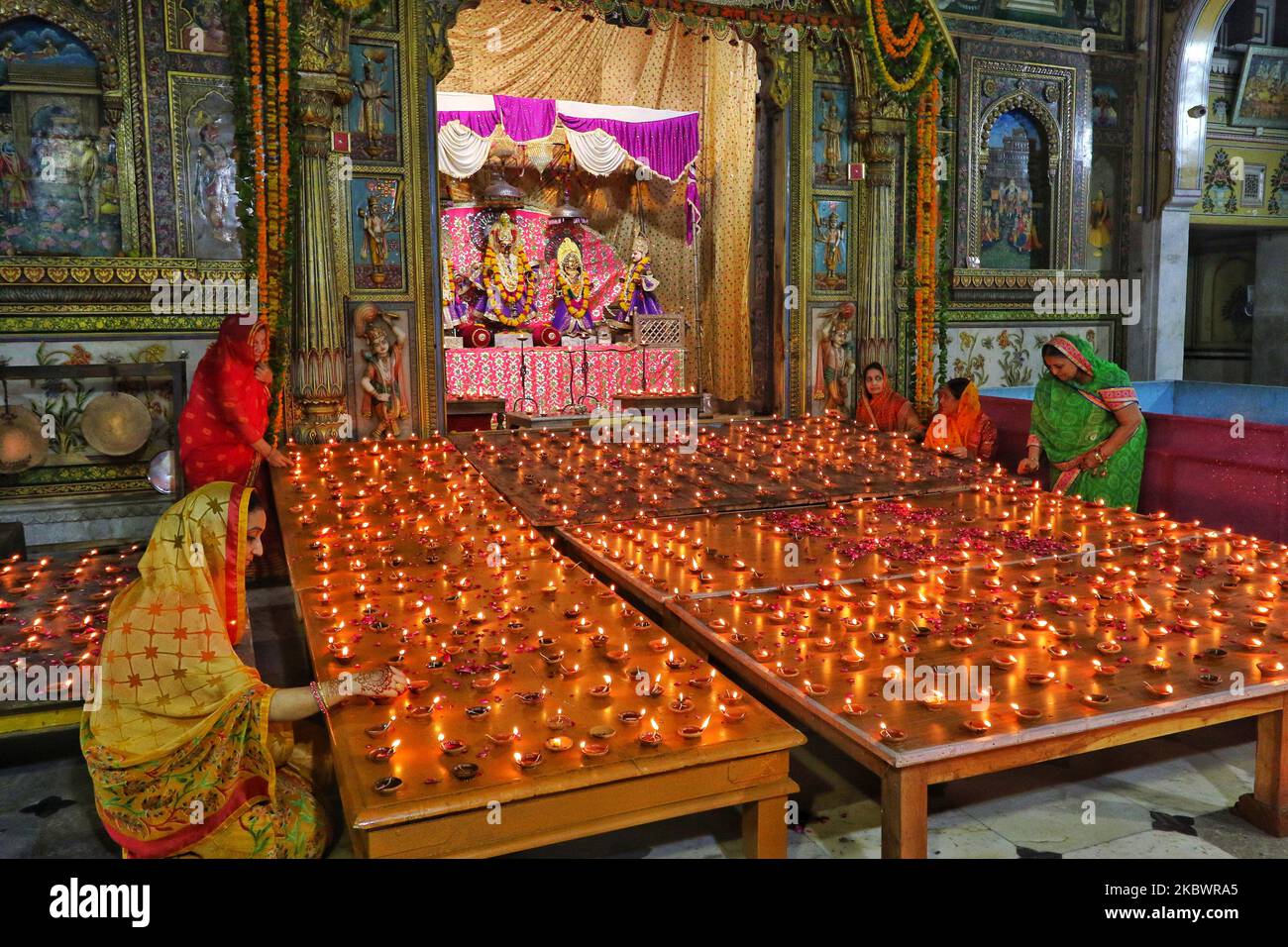Hindu devotees light earthen lamps at Ramchandra Ji Temple to celebrate
