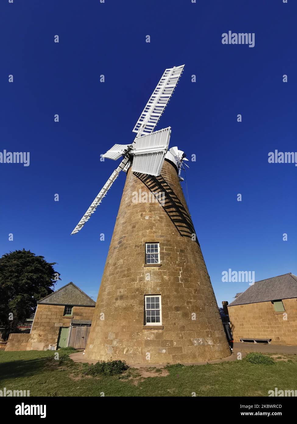 A Low angle shot of Callington Mill Distillery against a blue sky Stock Photo