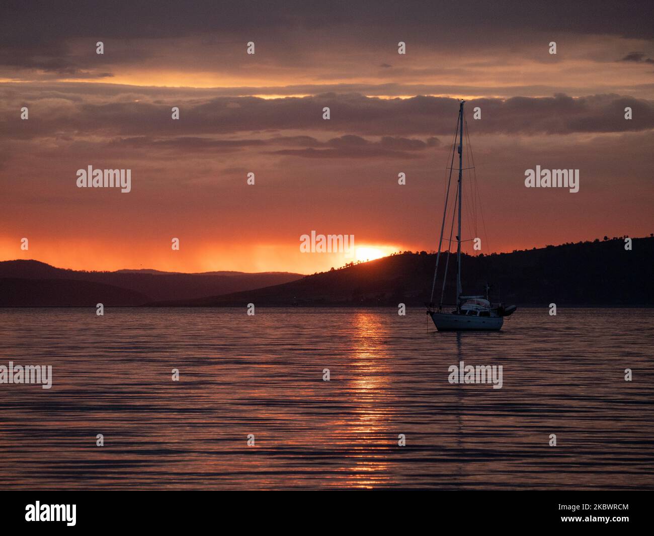 A Breathtaking sunset view with seascape and a silhouette of boat Stock ...