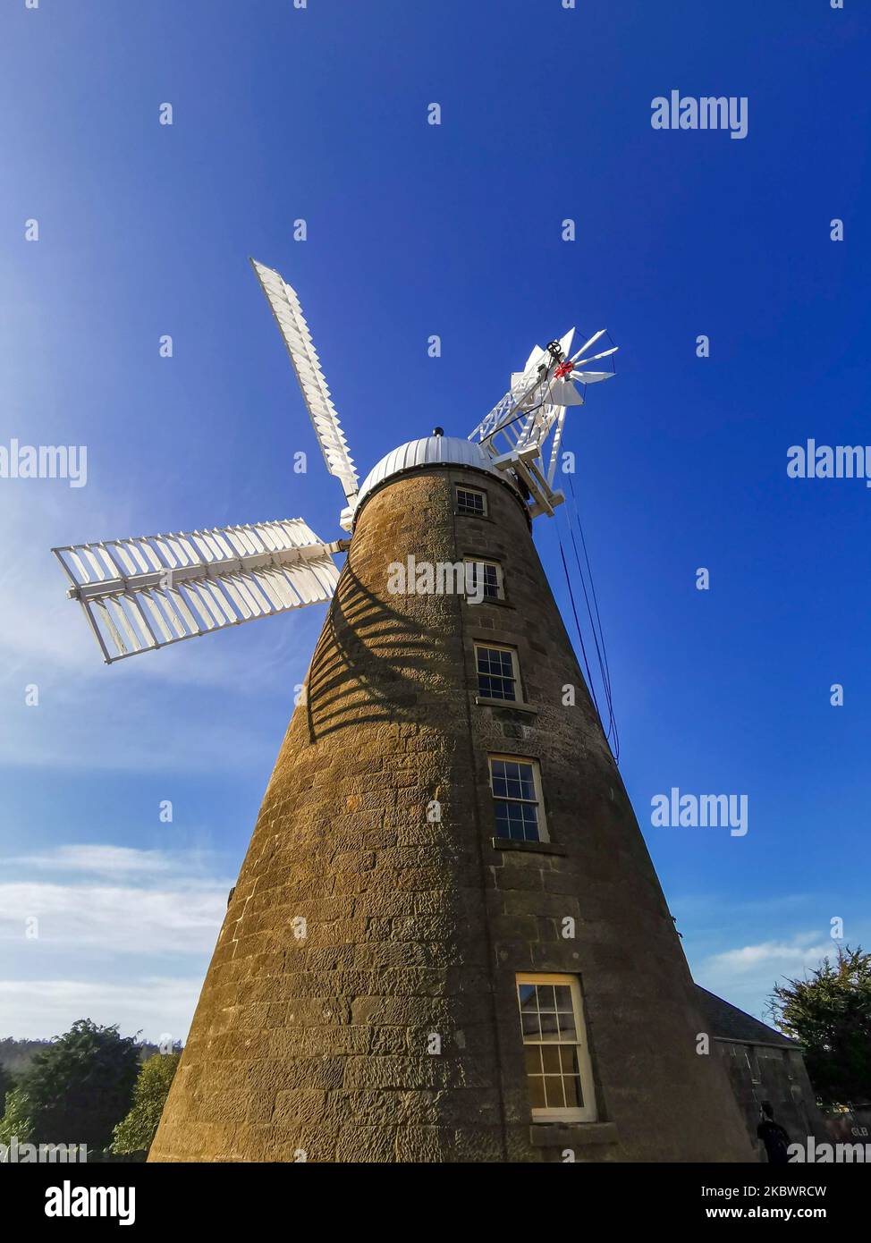 A Low angle shot of Callington Mill Distillery against a blue sky Stock Photo