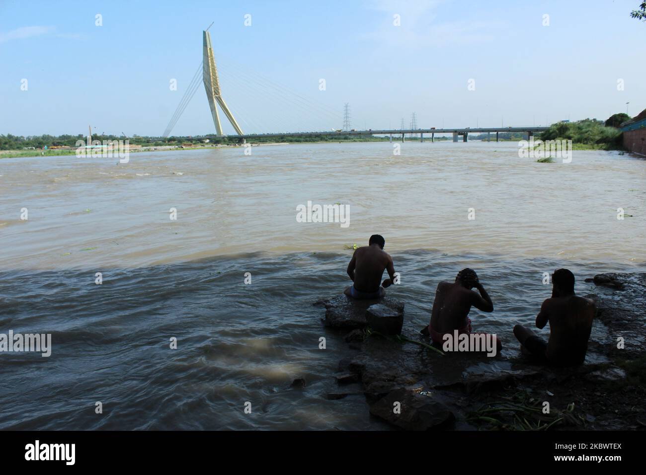 People bath in river Yamuna at Wazirabad barrage near Signature Bridge to get some relief from the rising temperature in the national capital New Delhi, India on August 4, 2020. (Photo by Mayank Makhija/NurPhoto) Stock Photo