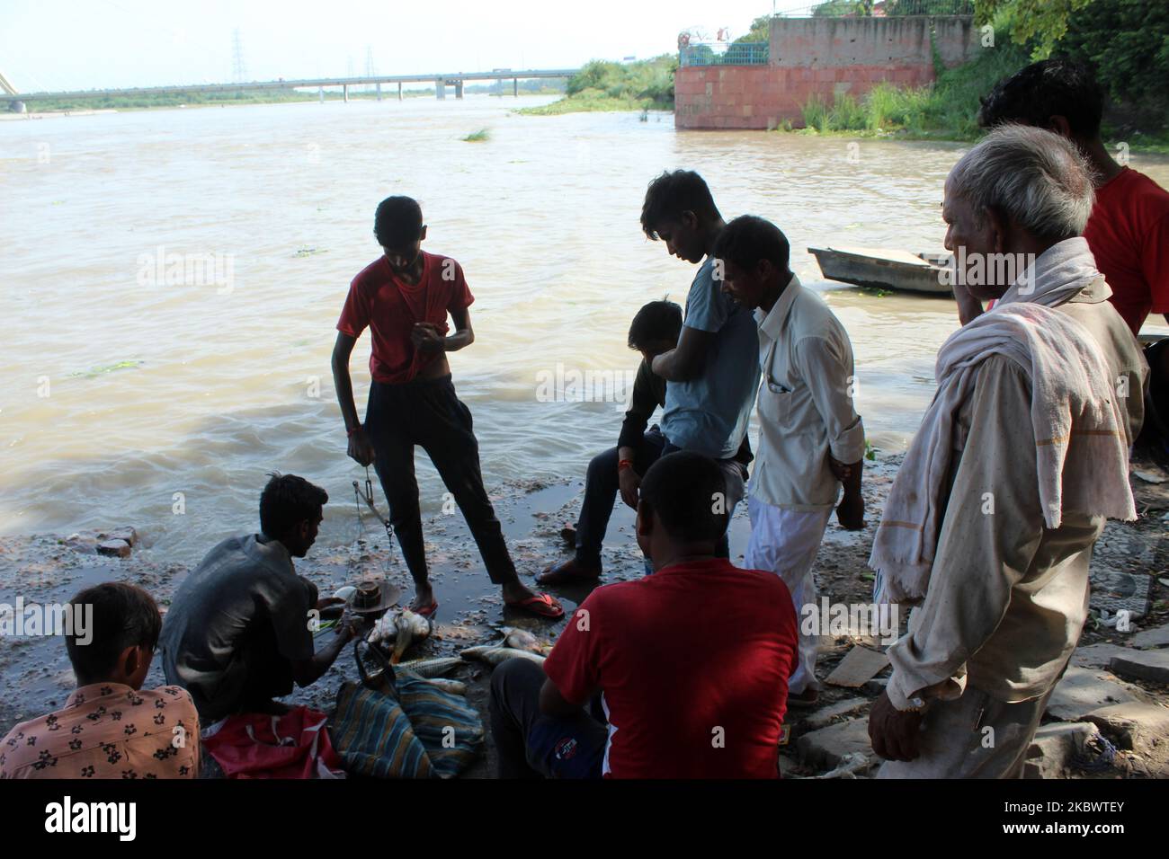 Fisherman sells freshly caught fishes from river Yamuna at Wazirabad barrage near Signature Bridge in the national capital New Delhi, India on August 4, 2020. (Photo by Mayank Makhija/NurPhoto) Stock Photo