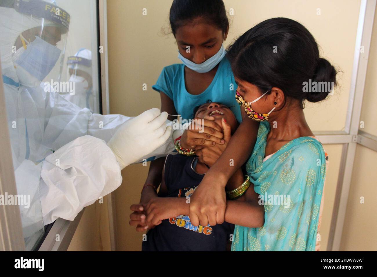 A medical staff collects a sample from a child for Rapid Antigen Test (RAT) for the COVID-19 coronavirus at Chacha Nehru Bal Chikitsalaya near Geeta Colony in New Delhi on August 7, 2020. India is now the third country to cross the two million mark. It reported 62,170 cases in the past 24 hours, taking its total tally up to 2,025,409. The country has reported around 40,700 deaths so far. (Photo by Mayank Makhija/NurPhoto) Stock Photo