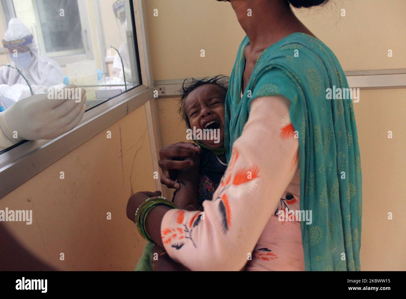 A medical staff collects a sample from a child for Rapid Antigen Test (RAT) for the COVID-19 coronavirus at Chacha Nehru Bal Chikitsalaya near Geeta Colony in New Delhi on August 7, 2020. India is now the third country to cross the two million mark. It reported 62,170 cases in the past 24 hours, taking its total tally up to 2,025,409. The country has reported around 40,700 deaths so far. (Photo by Mayank Makhija/NurPhoto) Stock Photo
