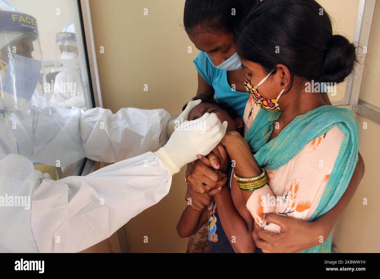 A medical staff collects a sample from a child for Rapid Antigen Test (RAT) for the COVID-19 coronavirus at Chacha Nehru Bal Chikitsalaya near Geeta Colony in New Delhi on August 7, 2020. India is now the third country to cross the two million mark. It reported 62,170 cases in the past 24 hours, taking its total tally up to 2,025,409. The country has reported around 40,700 deaths so far. (Photo by Mayank Makhija/NurPhoto) Stock Photo