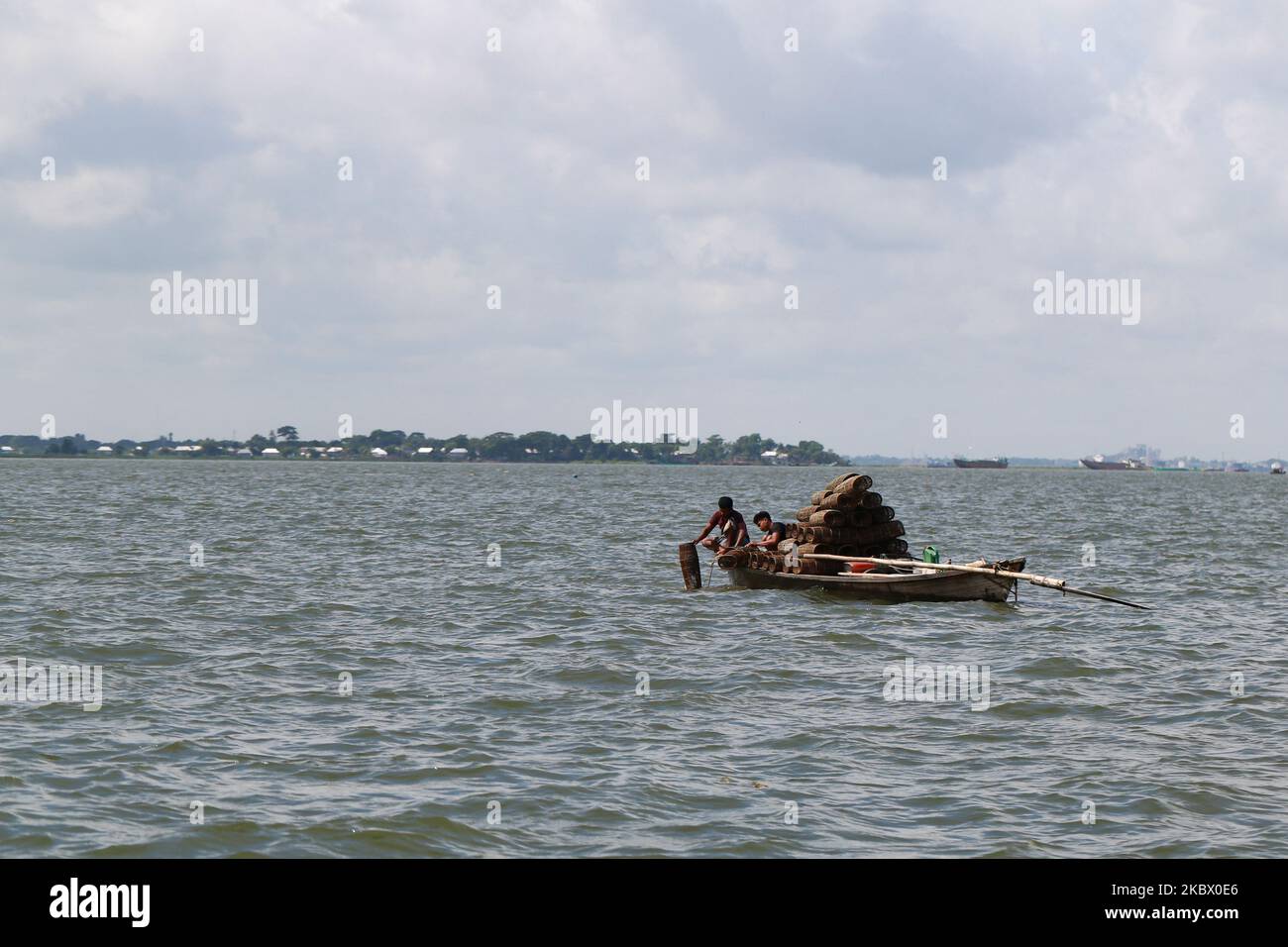 Fishermen are seen catch fishes on the Meghna River in Narayanganj, near Dhaka, Bangladesh on August 10, 2020. (Photo by Rehman Asad/NurPhoto) Stock Photo